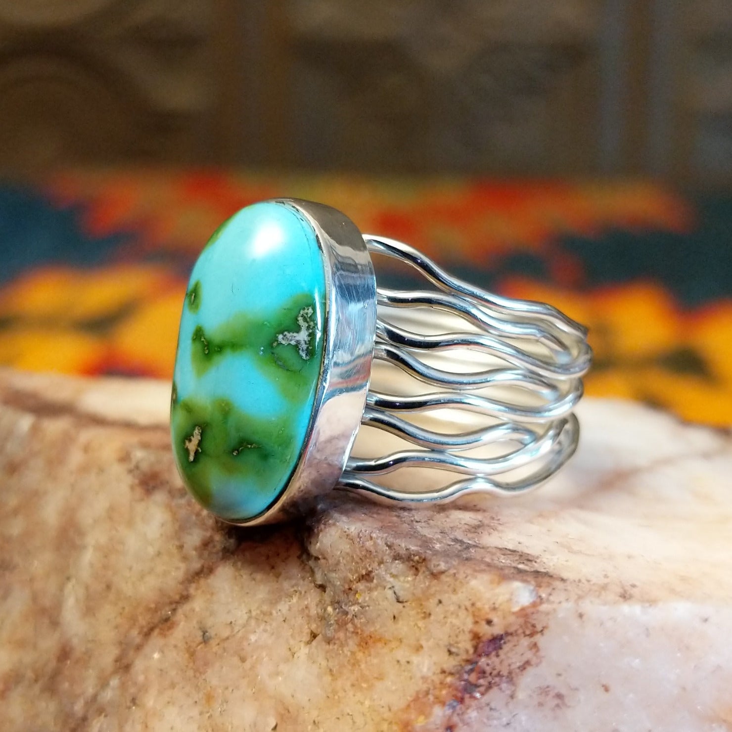Sonoran Gold Turquoise oval stone in a strand-style setting, set in sterling silver. Made by Murphy Platero, this ring is size 8, side view.