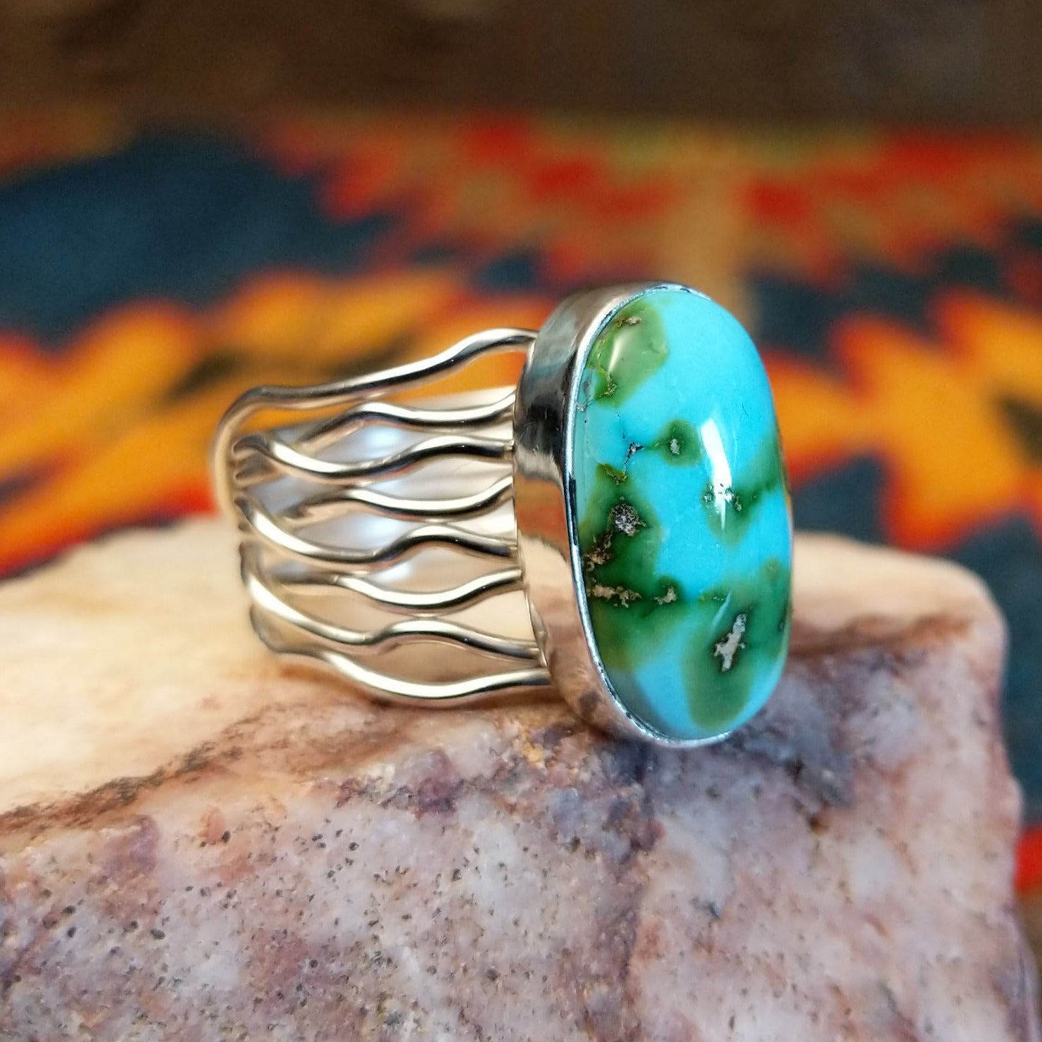 Sonoran Gold Turquoise oval stone in a strand-style setting, set in sterling silver. Made by Murphy Platero, this ring is size 8, side view.