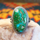 Sonoran Gold Turquoise stone set in a classic trifurcate sterling silver band. Made by Roie Jaque, this ring is size 10, front view.