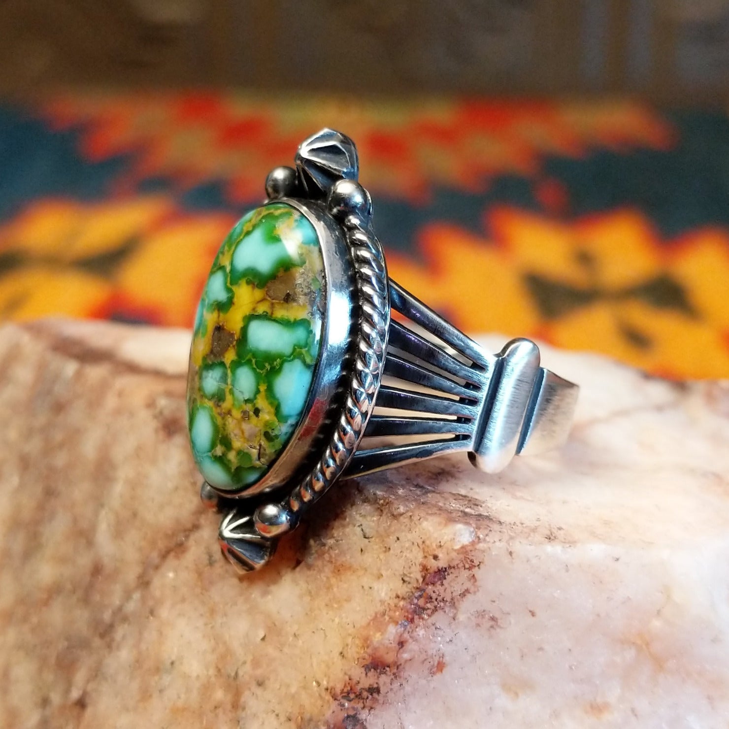  Sonoran Gold Turquoise stone in a framed design, set in sterling silver. Made by Lowell Draper, this ring is size 10, side view.
