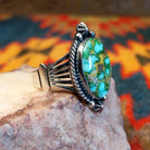  Sonoran Gold Turquoise stone in a framed design, set in sterling silver. Made by Lowell Draper, this ring is size 10, side view.