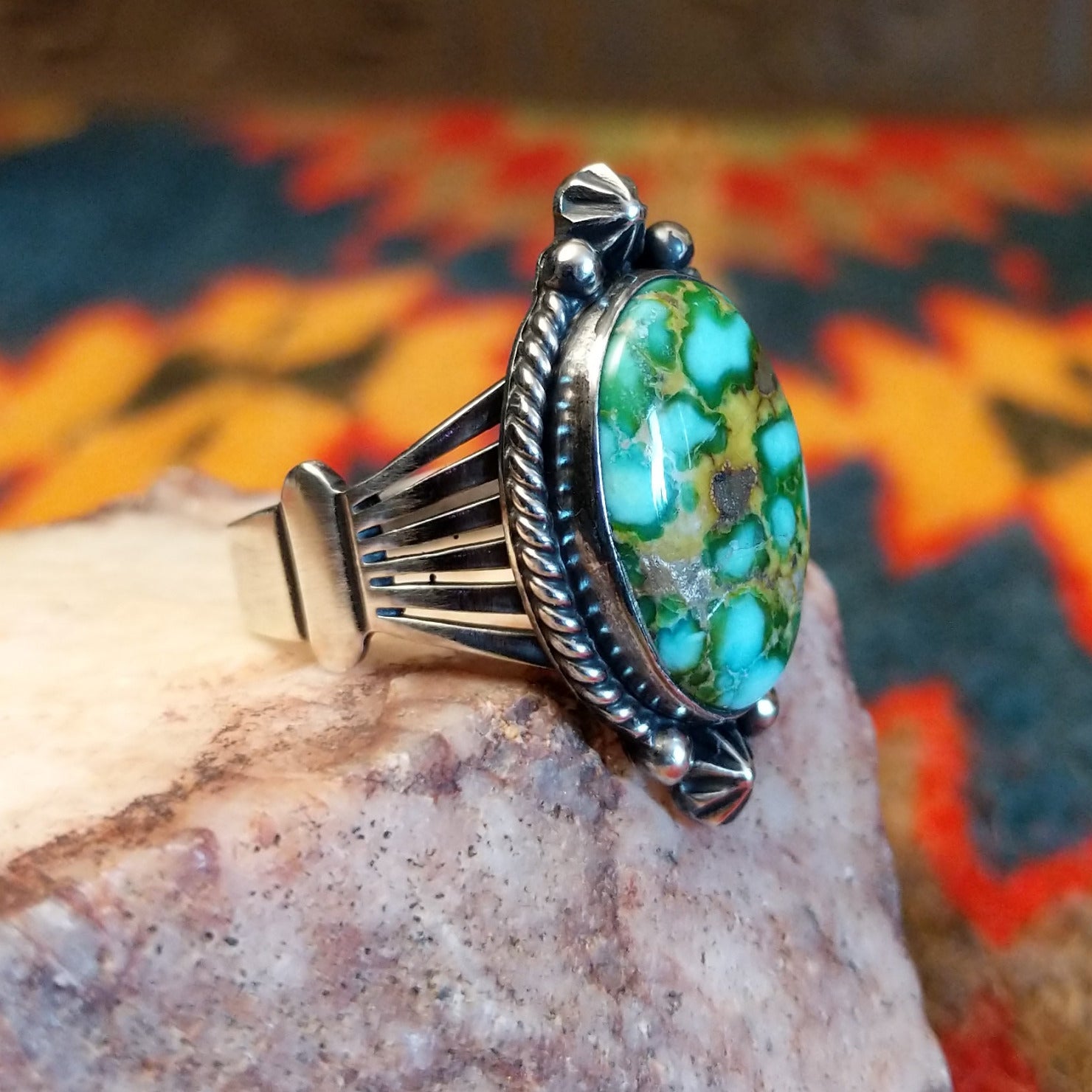  Sonoran Gold Turquoise stone in a framed design, set in sterling silver. Made by Lowell Draper, this ring is size 10, side view.
