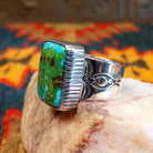  Sonoran Gold Turquoise stone in a bold rectangular cut, set in sterling silver. This Navajo-made ring is size 11, side view with band detail.