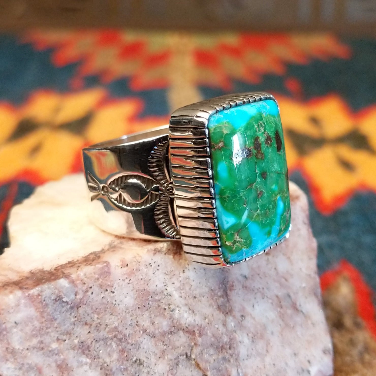  Sonoran Gold Turquoise stone in a bold rectangular cut, set in sterling silver. This Navajo-made ring is size 11, side view with band detail.