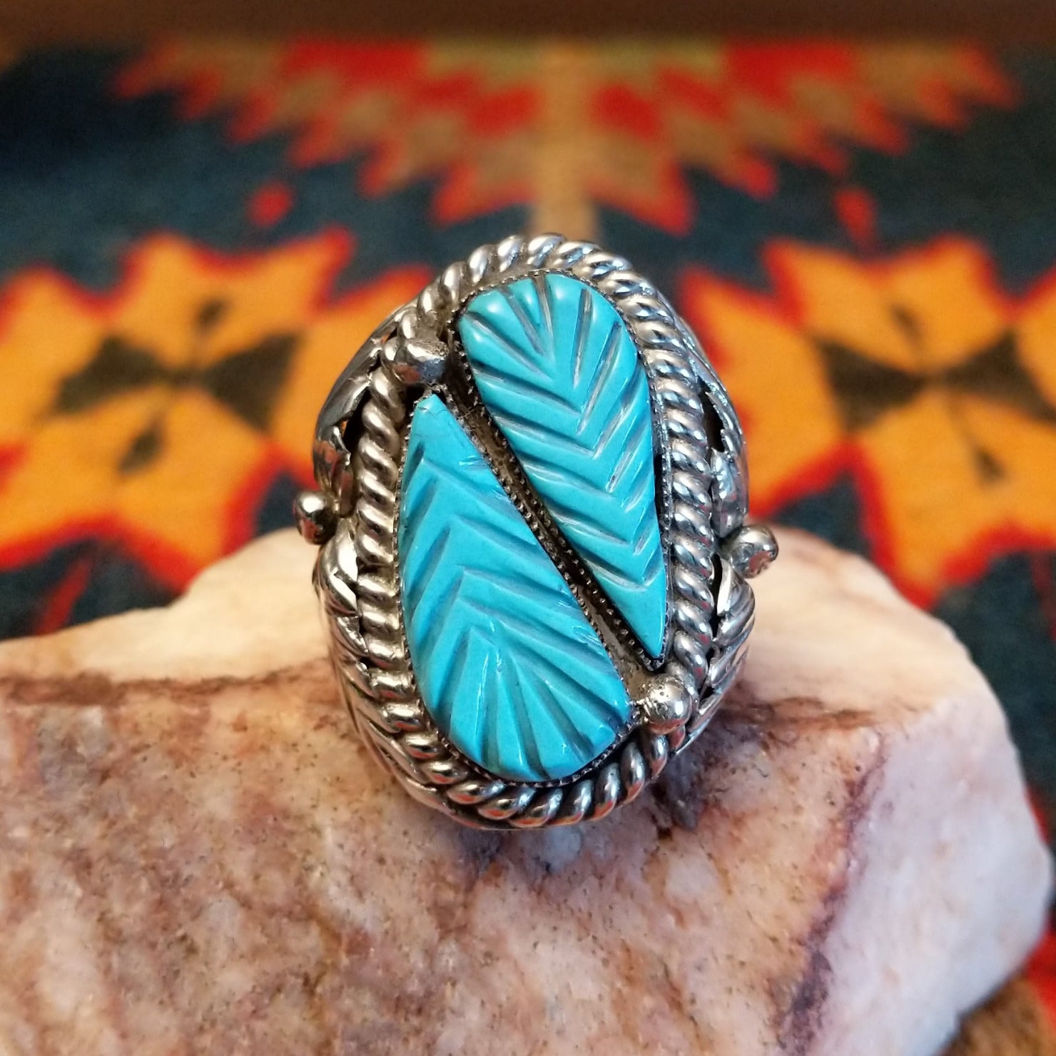  Size 9.75 Navajo ring, set in Sterling Silver, features a beautifully carved turquoise centerpiece set in sterling silver. Front view