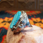  Size 9.75 Navajo ring, set in Sterling Silver, features a beautifully carved turquoise centerpiece set in sterling silver. Side view