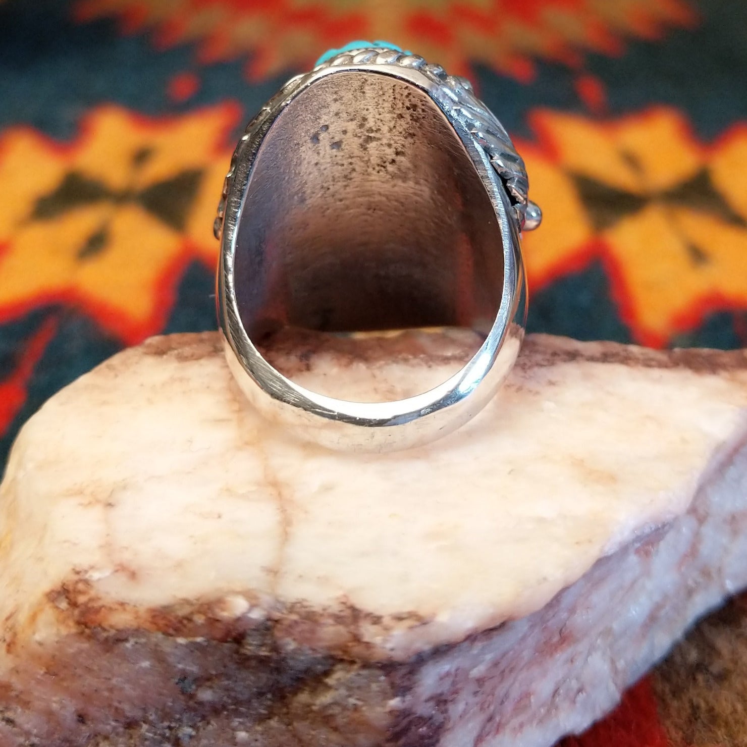  Size 9.75 Navajo ring, set in Sterling Silver, features a beautifully carved turquoise centerpiece set in sterling silver. Underside of ring view