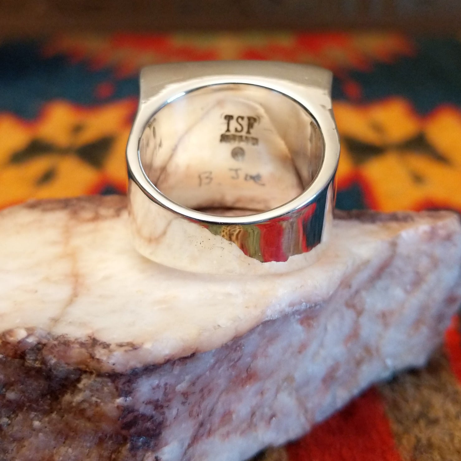 Artisan and Sterling Silver stamp on underside of ring.