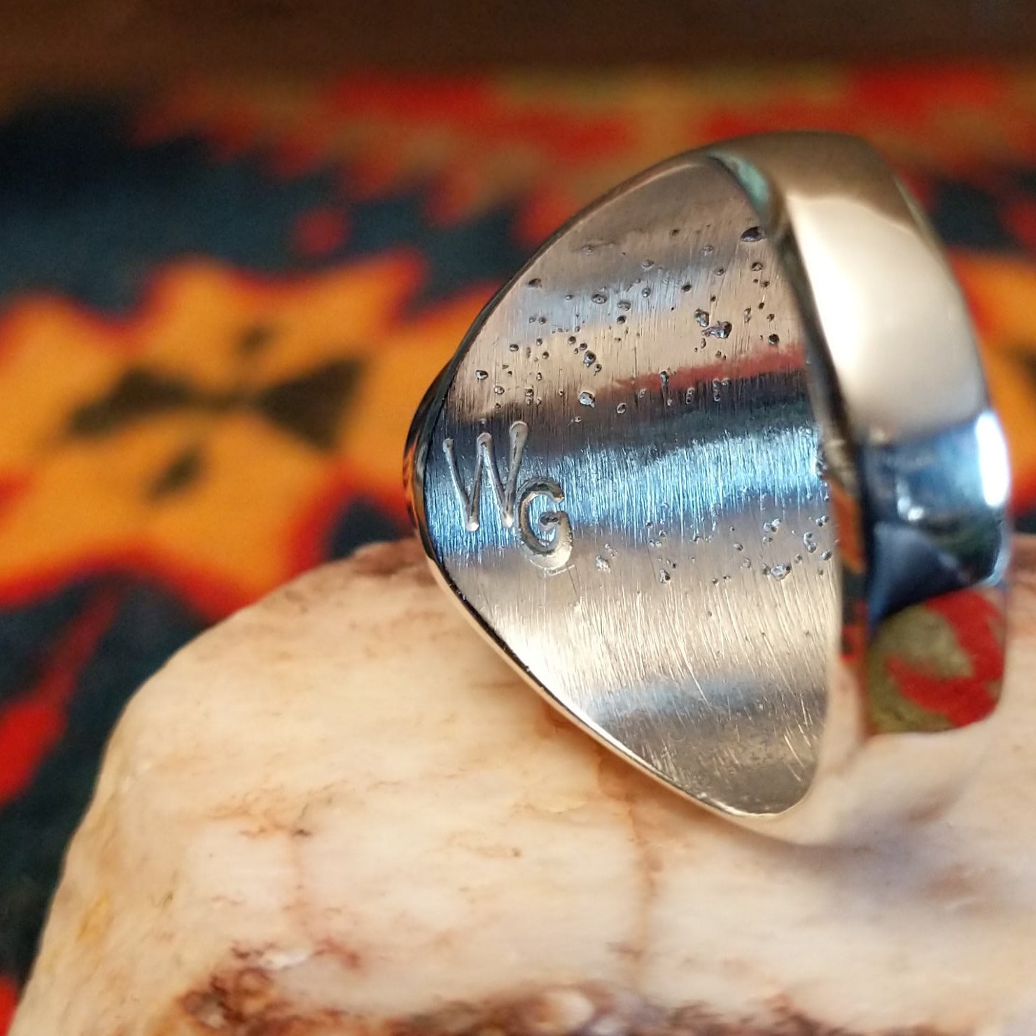 Artisan stamp on underside of ring.