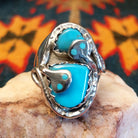 Size 12 ring by Gloria G., daughter of Effie Calavaza, beautifully carries on the iconic Zuni tradition.  Turquoise stones set in Sterling Silver.  Front view 