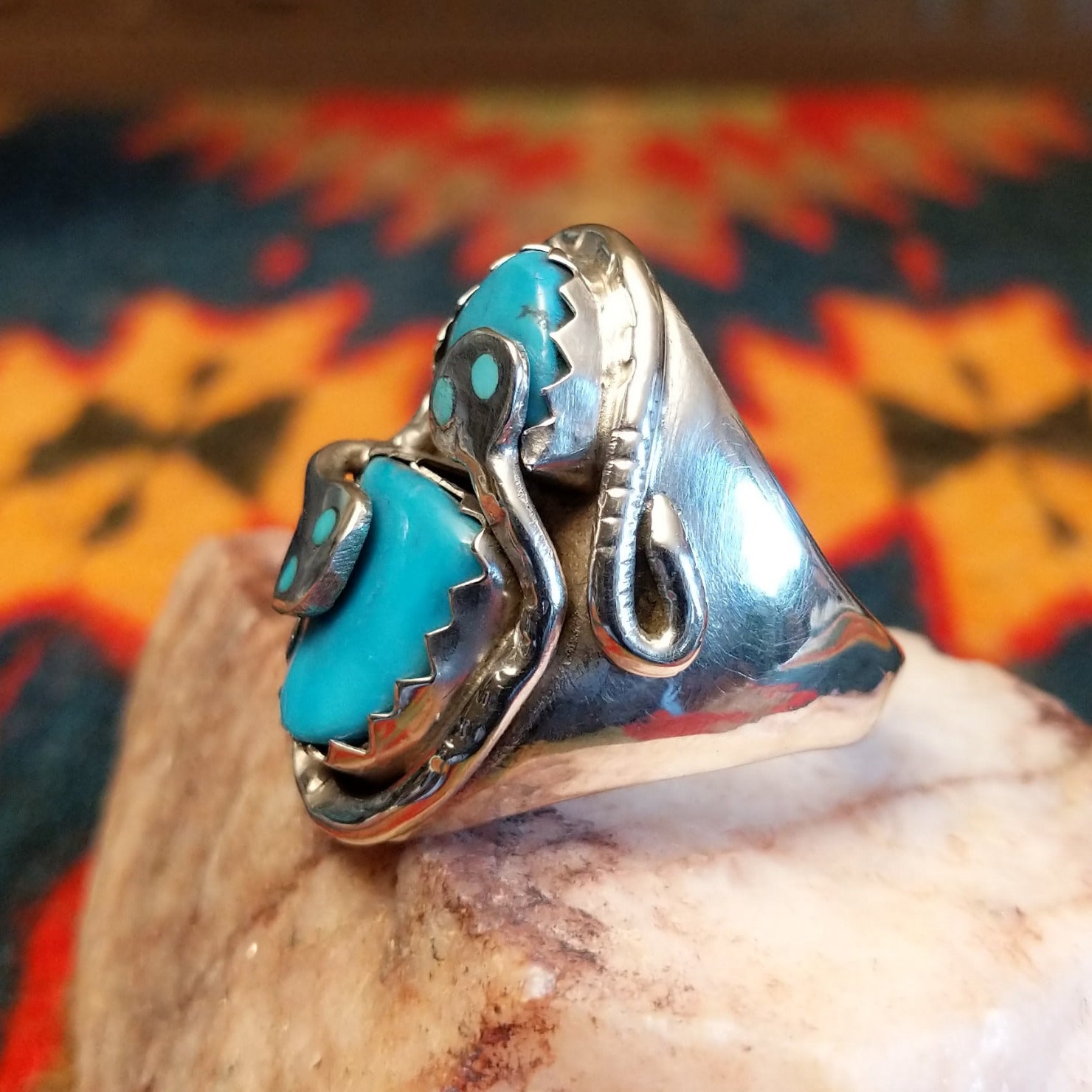 Size 12 ring by Gloria G., daughter of Effie Calavaza, beautifully carries on the iconic Zuni tradition.  Turquoise stones set in Sterling Silver. Side view