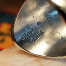 Artisan stamp on underside of ring.