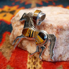 Navajo horse pendant handcrafted in sterling silver and showcases a dynamic inlay of Tiger’s Eye, Black Onyx, and Picture Jasper. Side view