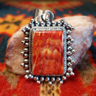 Handcrafted pendant by Verna Blackgoat features vibrant Red Spiny Oyster Shell. Front view