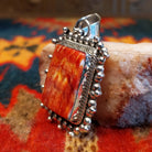 Handcrafted pendant by Verna Blackgoat features vibrant Red Spiny Oyster Shell. Side view