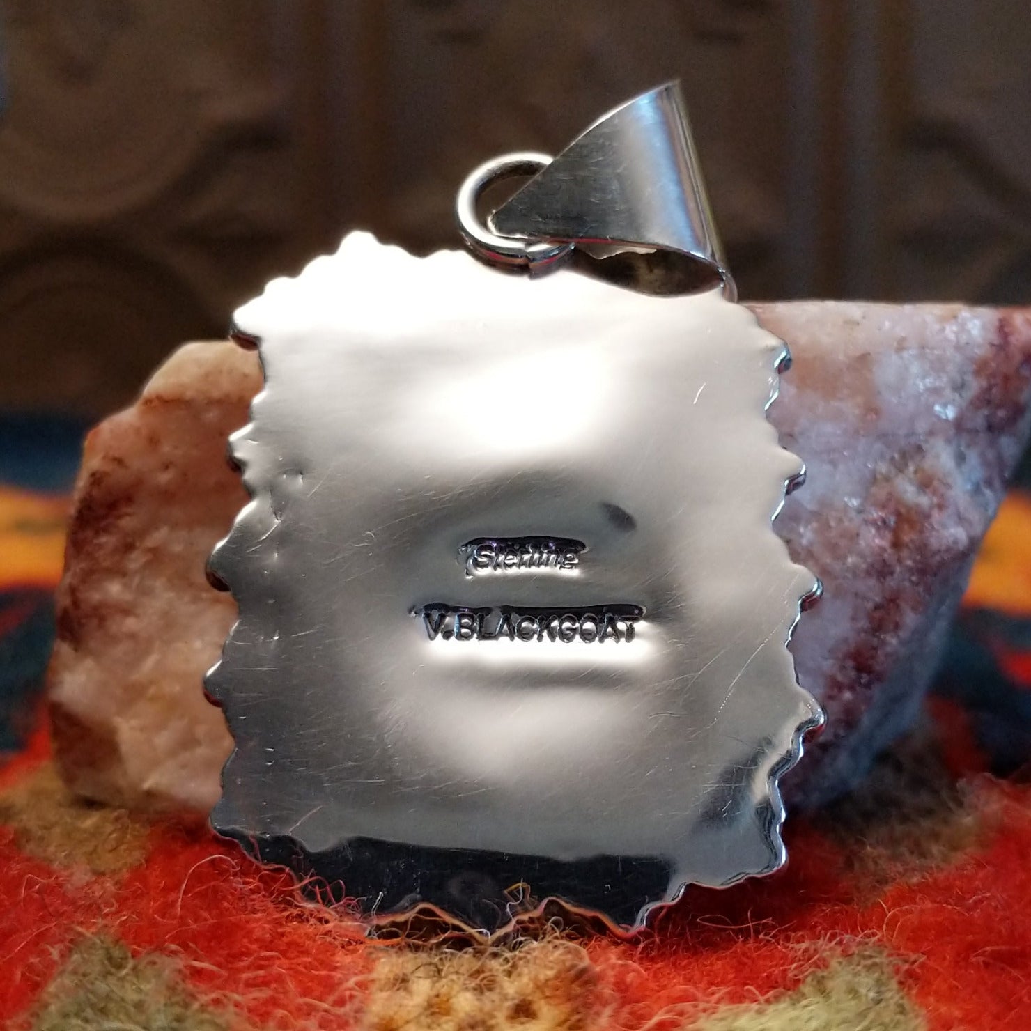 Artisan and Sterling Silver stamp on back of pendant.