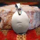 Artisan and Sterling Silver stamp on back of pendant.