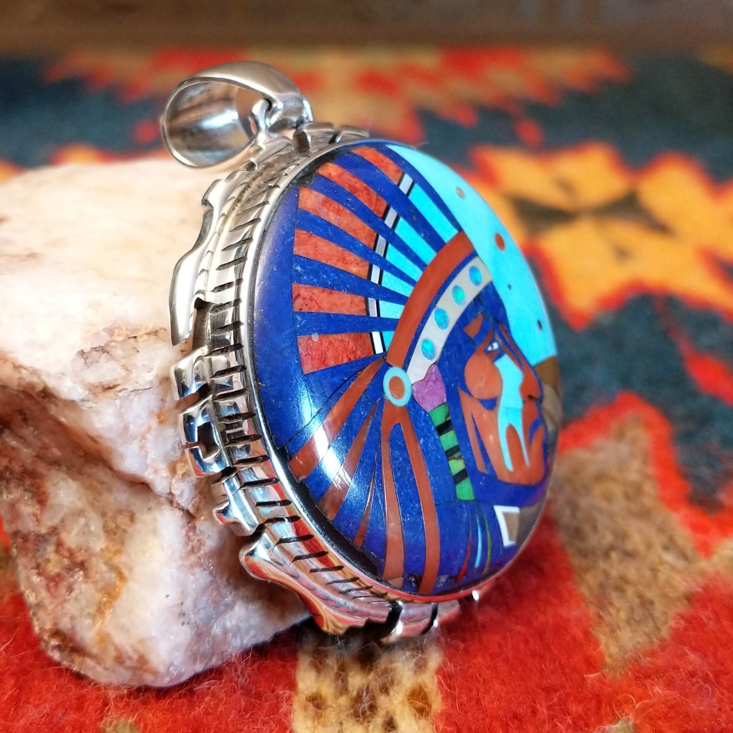 Sterling Silver Navajo “Crying Chief” Pendant featuring turquoise, lapis, mother of pearl, blue manmade opal, magnesite, and gaspeite.  Side view