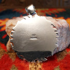 Artisan and Sterling Silver stamp on back of pendant.
