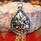 Navajo Eagle pendant  handcrafted in sterling silver, featuring a soaring eagle set within a feathered and scrollwork frame.  Front view