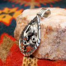 Navajo Eagle pendant  handcrafted in sterling silver, featuring a soaring eagle set within a feathered and scrollwork frame.  Side view