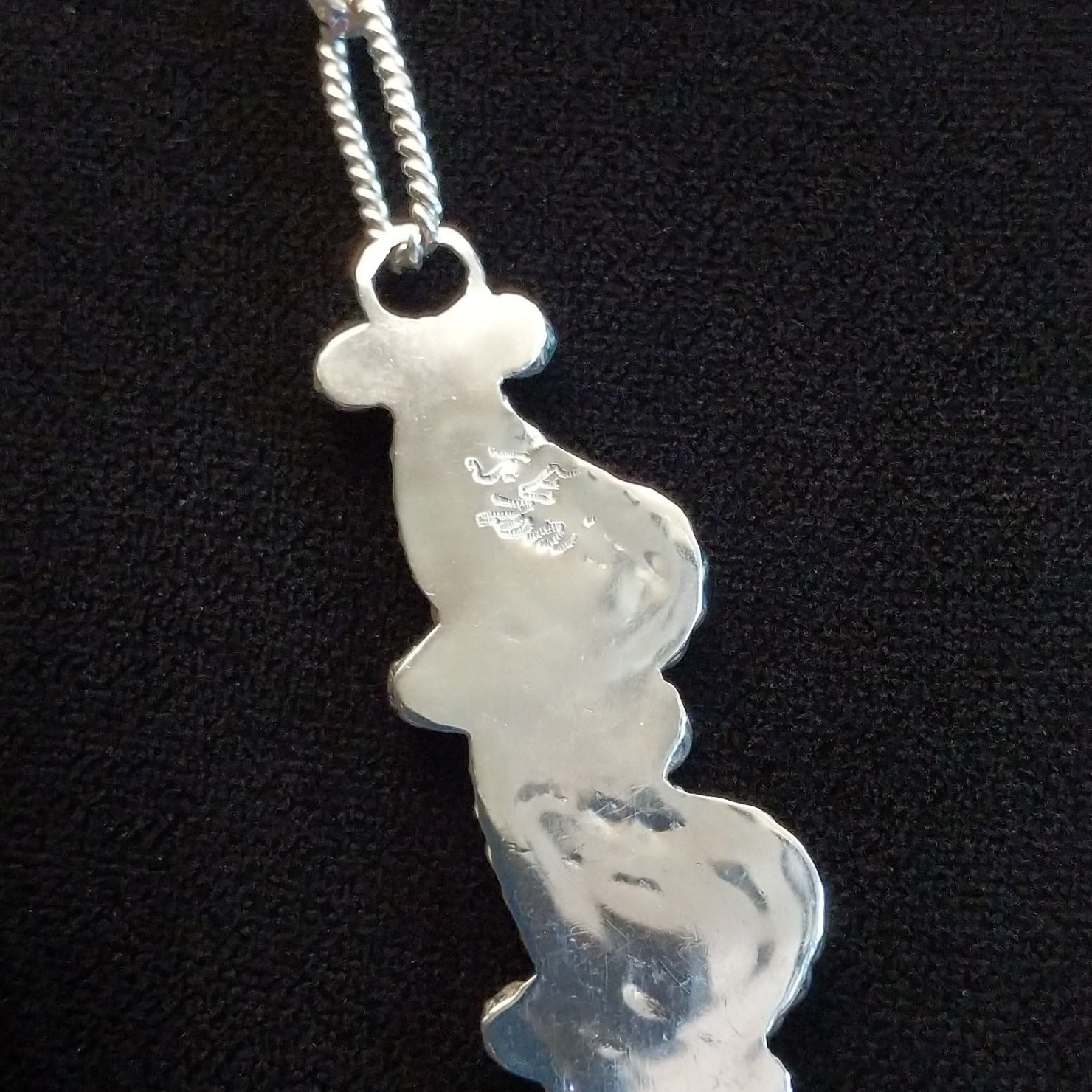 Close up of artisan hallmark on back of one part of the necklace.