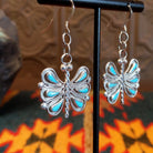 Butterfly-shaped earrings with turquoise on a stand, size view.