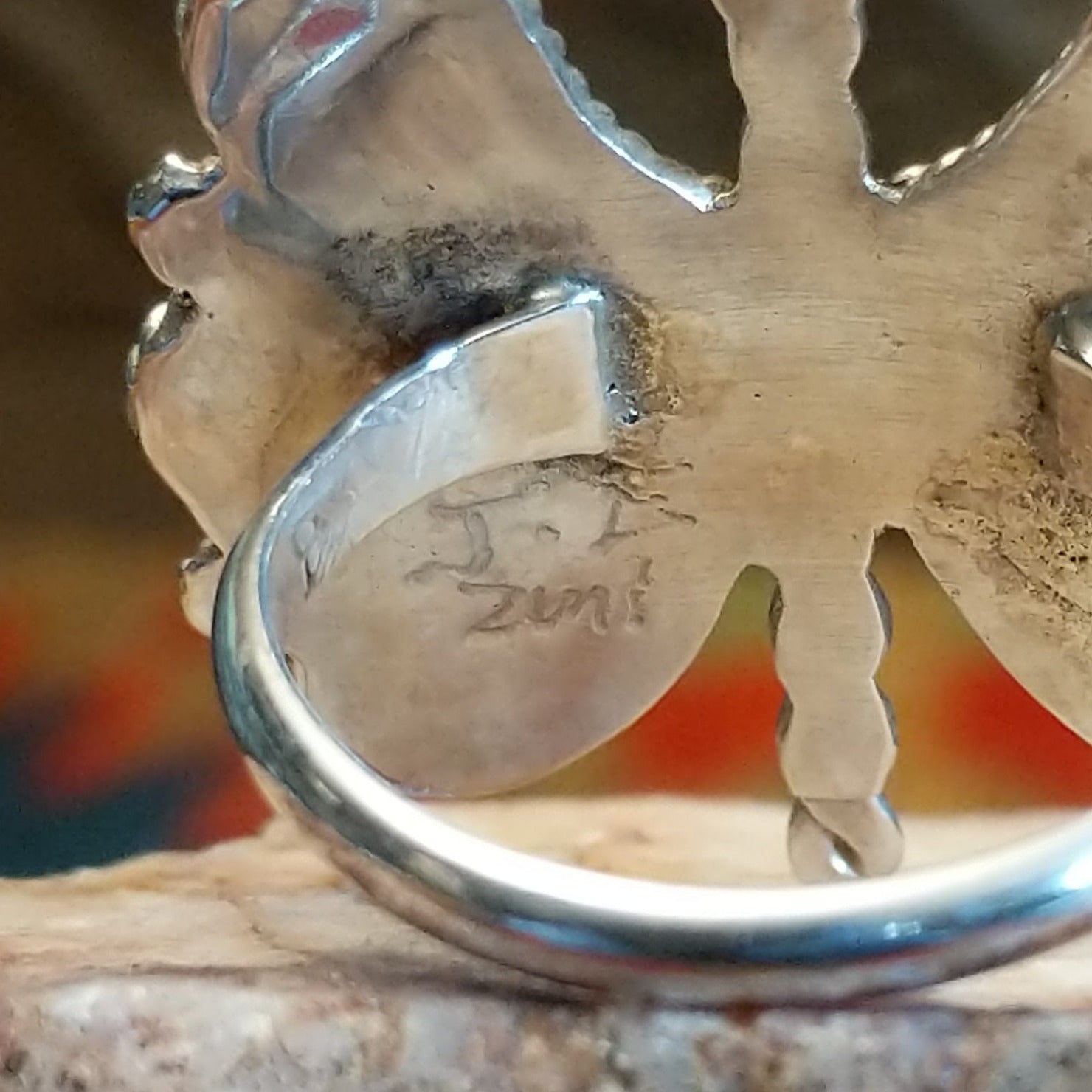Butterfly-shaped silver and turquoise ring, back size view showing artisan hallmark.