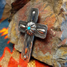 Sterling silver stamped cross pendant with small turquoise by Navajo artisan Charlene Yazzie., right side view