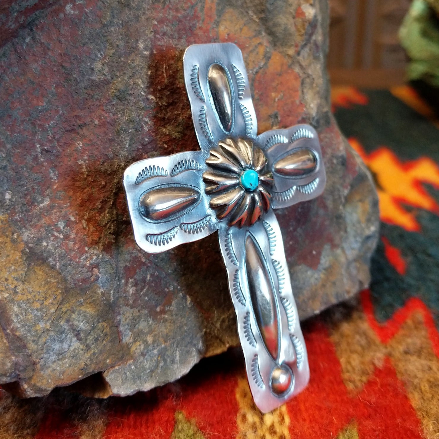 Sterling silver stamped cross pendant with small turquoise by Navajo artisan Charlene Yazzie. , left side view