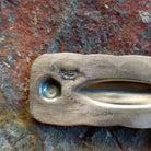 close up of artisan signature on back of Sterling silver stamped cross pendant with small turquoise by Navajo artisan Charlene Yazzie.