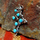 Sterling silver cross pendant with snake eye turquoise stones by Zuni artisan L.B. , side view