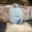 Domed sterling silver pendant featuring a polished Sonoran Gold turquoise stone with blue-green coloring and natural golden matrix, handcrafted by Navajo artist Burt Francisco.  Back view with artisan and silver stamp.