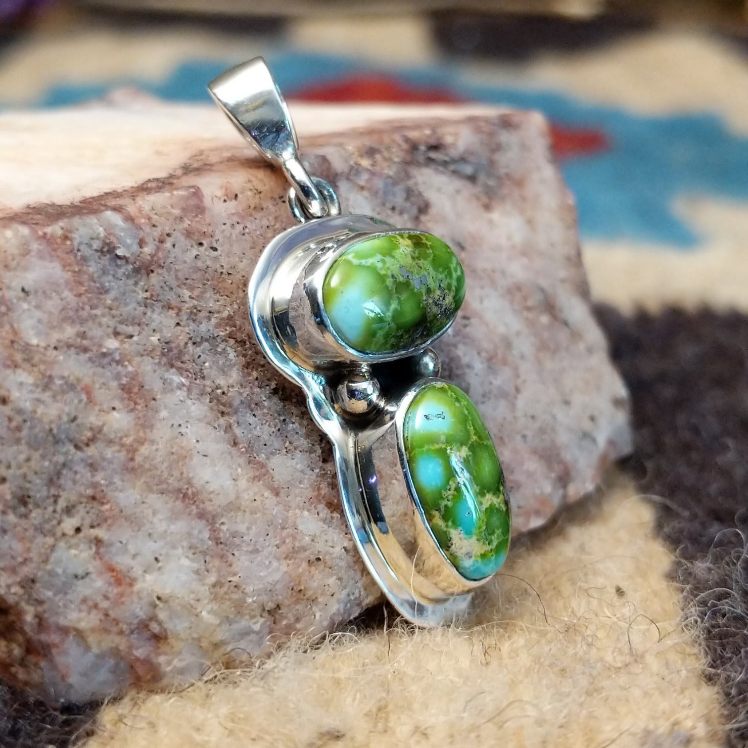 Sterling silver pendant with arranged Sonoran Gold turquoise stones displaying blue-green hues and natural golden matrix, handcrafted by artisan L.P.  Side view.