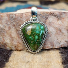 Triangular sterling silver pendant featuring a polished Sonoran Gold turquoise stone with blue-green tones and natural golden matrix, handcrafted by Navajo artist Artie Yellowhorse.  Front view.