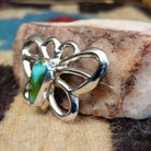 Sterling silver butterfly pin featuring Sonoran Gold turquoise stones with blue-green hues and natural golden matrix, handcrafted by Native American artist Francis Jones.  Side view.