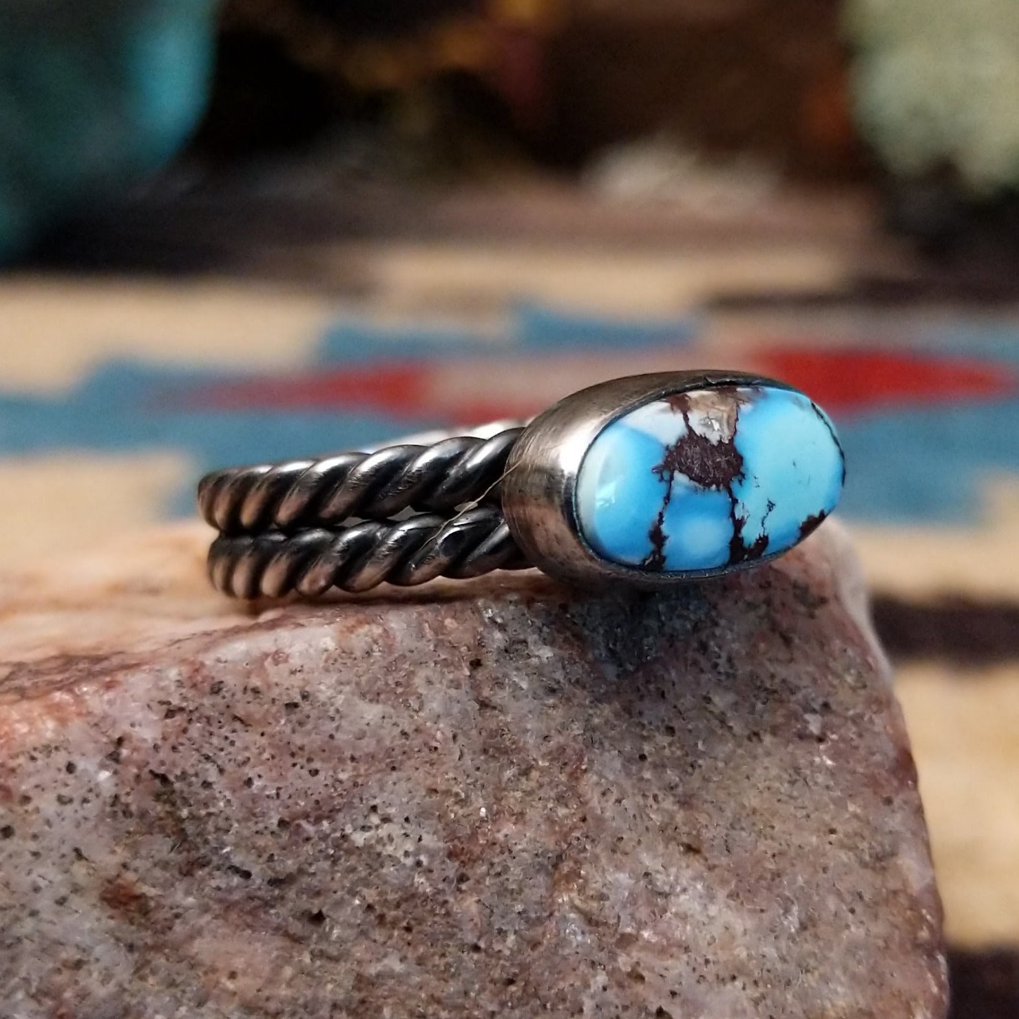 Navajo sterling silver ring with an oval Golden Hills turquoise stone and twisted silver band in a classic Southwestern design.  Side view.