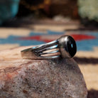 Sterling silver split-band ring by Raymond Coriz featuring a polished black onyx stone in a sleek Southwestern design.  Side view.