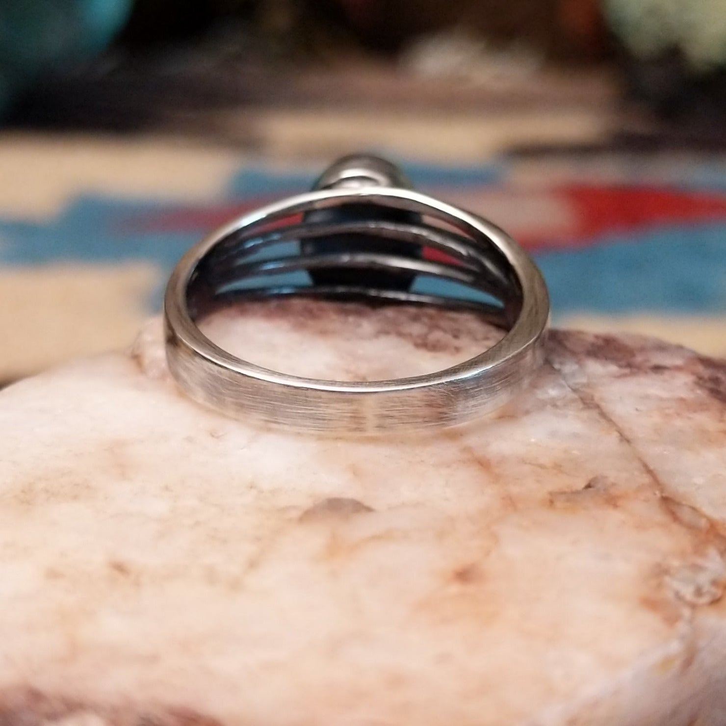 Sterling silver split-band ring by Raymond Coriz featuring a polished black onyx stone in a sleek Southwestern design.  Underside view.