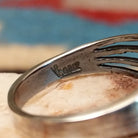 Sterling silver split-band ring by Raymond Coriz featuring a polished black onyx stone in a sleek Southwestern design.  Artisan stamp.