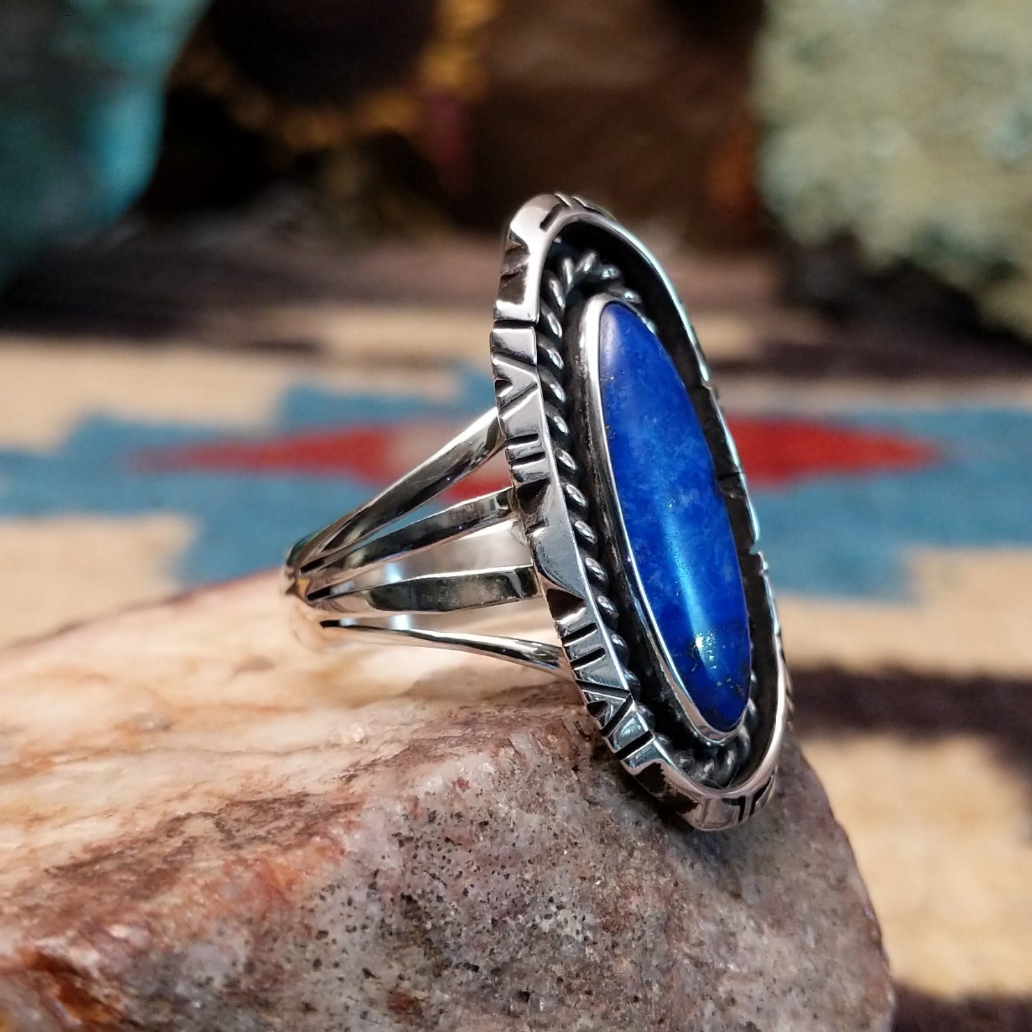 Sterling silver navette ring by Verdy Jake featuring a deep blue lapis stone in a classic Southwestern design.  Side view.