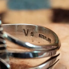 Sterling silver navette ring by Verdy Jake featuring a deep blue lapis stone in a classic Southwestern design.  Artisan and silver stamp.