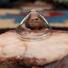 Navajo sterling silver ring with an oval Bumblebee Jasper stone featuring bold yellow, orange, black, and cream natural patterns.  Underside view.
