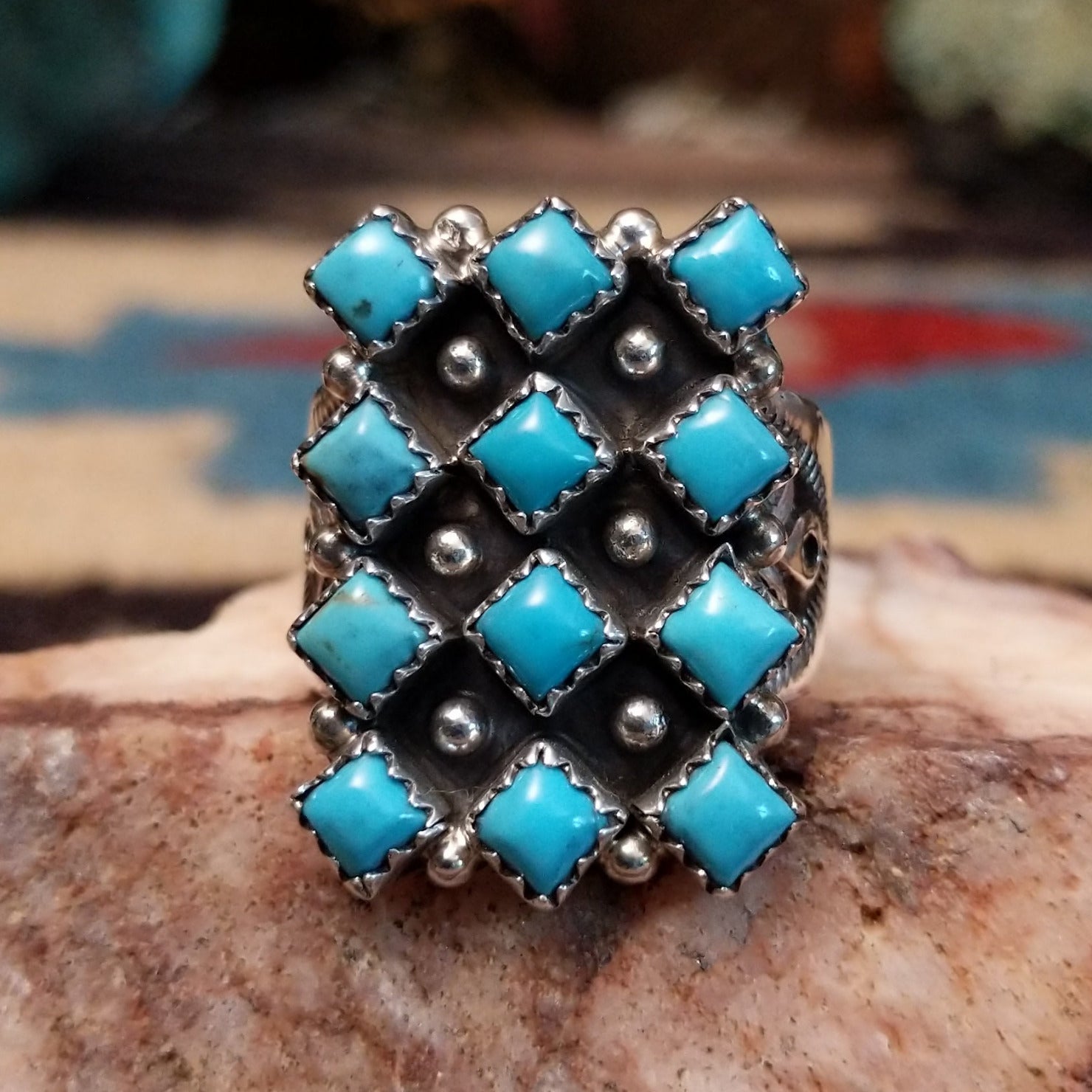 Sterling silver turquoise cluster ring by Verley Betone featuring multiple blue turquoise stones in a traditional Navajo floral-inspired design.  Front view.