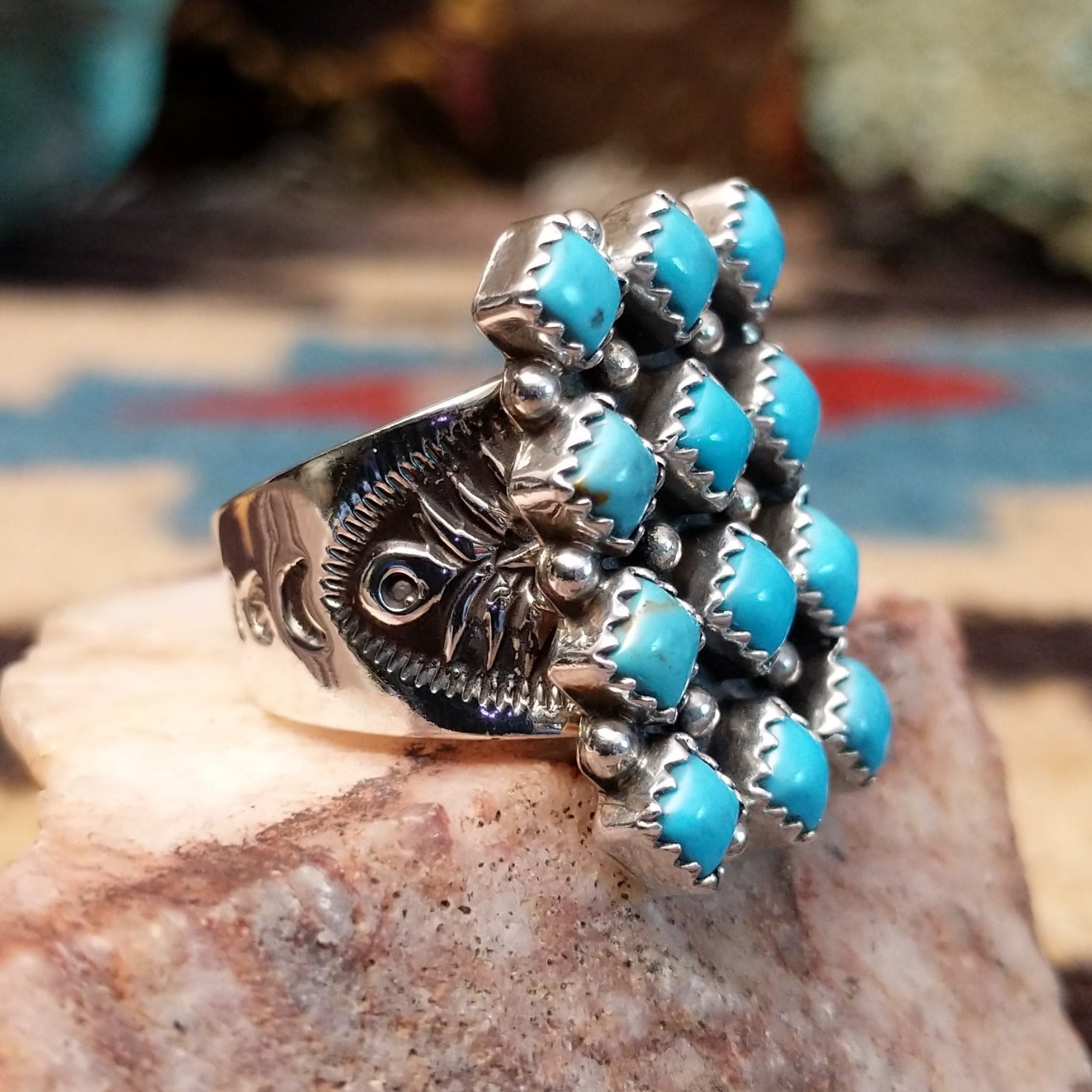 Sterling silver turquoise cluster ring by Verley Betone featuring multiple blue turquoise stones in a traditional Navajo floral-inspired design.  Side view.