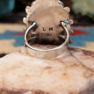 Sterling silver floral coral ring by Lorraine Waatsa featuring a vibrant red coral stone in a detailed Southwestern design.  Underside view.