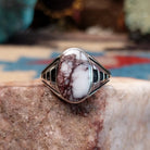 Navajo sterling silver ring with an oval Wild Horse stone featuring natural white and brown patterns in a classic Southwestern design.  Front view.