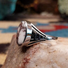 Navajo sterling silver ring with an oval Wild Horse stone featuring natural white and brown patterns in a classic Southwestern design.  Side view.