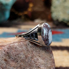 Navajo sterling silver ring with an oval Wild Horse stone featuring natural white and brown patterns in a classic Southwestern design.  Side view.