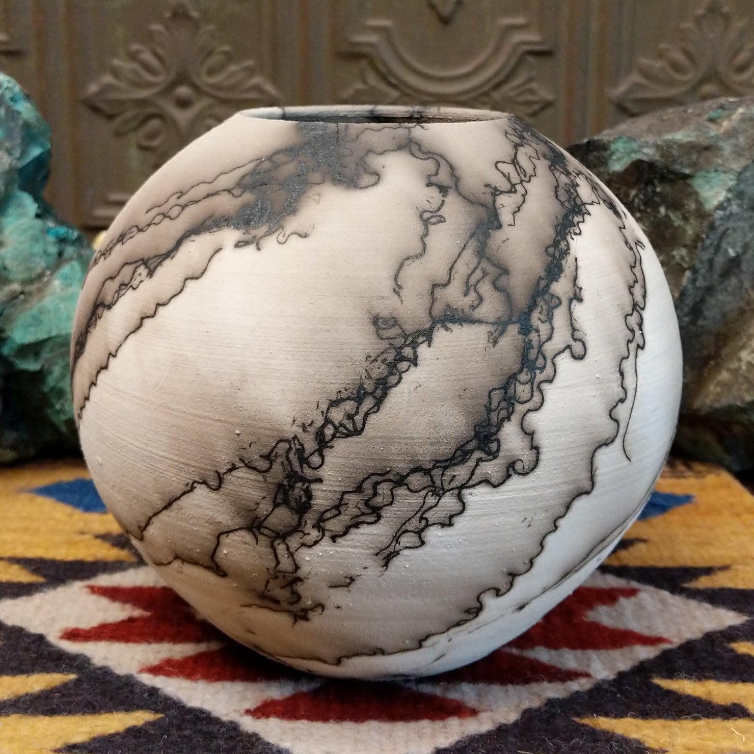 Medium globe-shaped white horsehair pottery vase by local artist Jim Calhoun featuring smoky organic patterns, a polished finish, and Southwestern handcrafted design.
